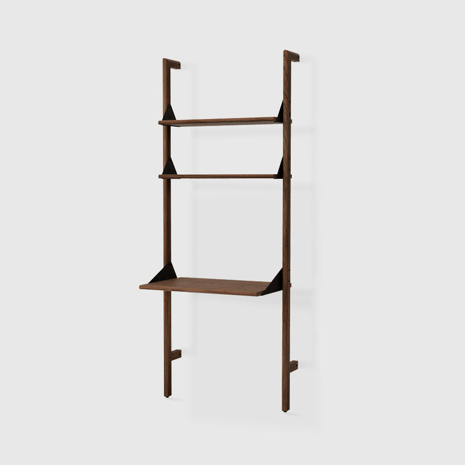 Branch-1 Shelving Unit with Desk by Gus* — walnut uprights and shelves with black brackets, three-quarter studio view
