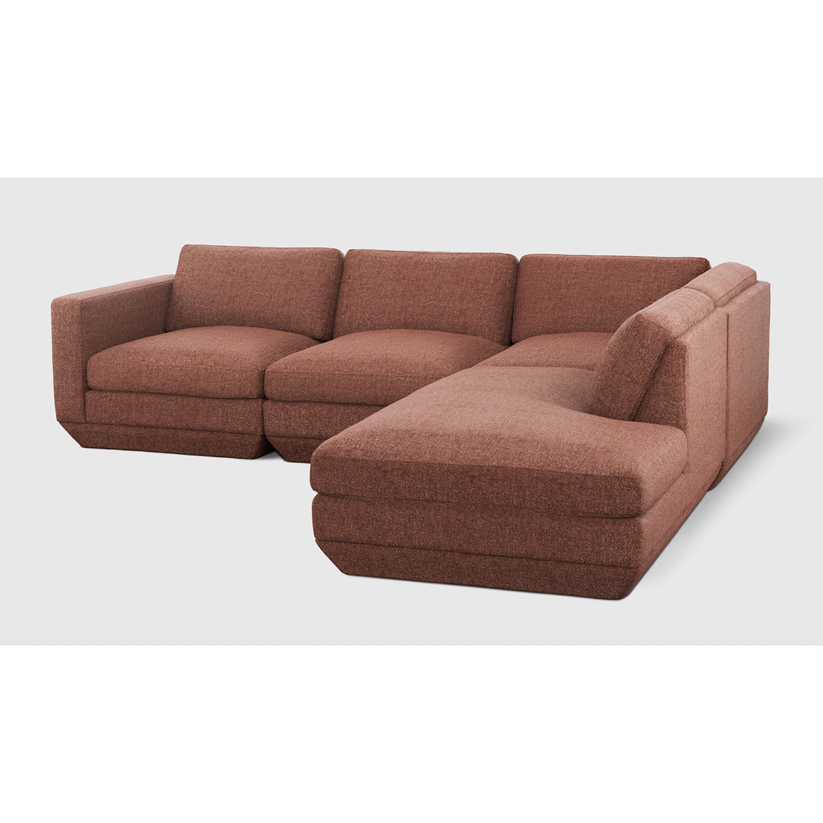 Podium Modular 4PC Lounge Sectional A by Gus* with rust-colored upholstery, angled view.