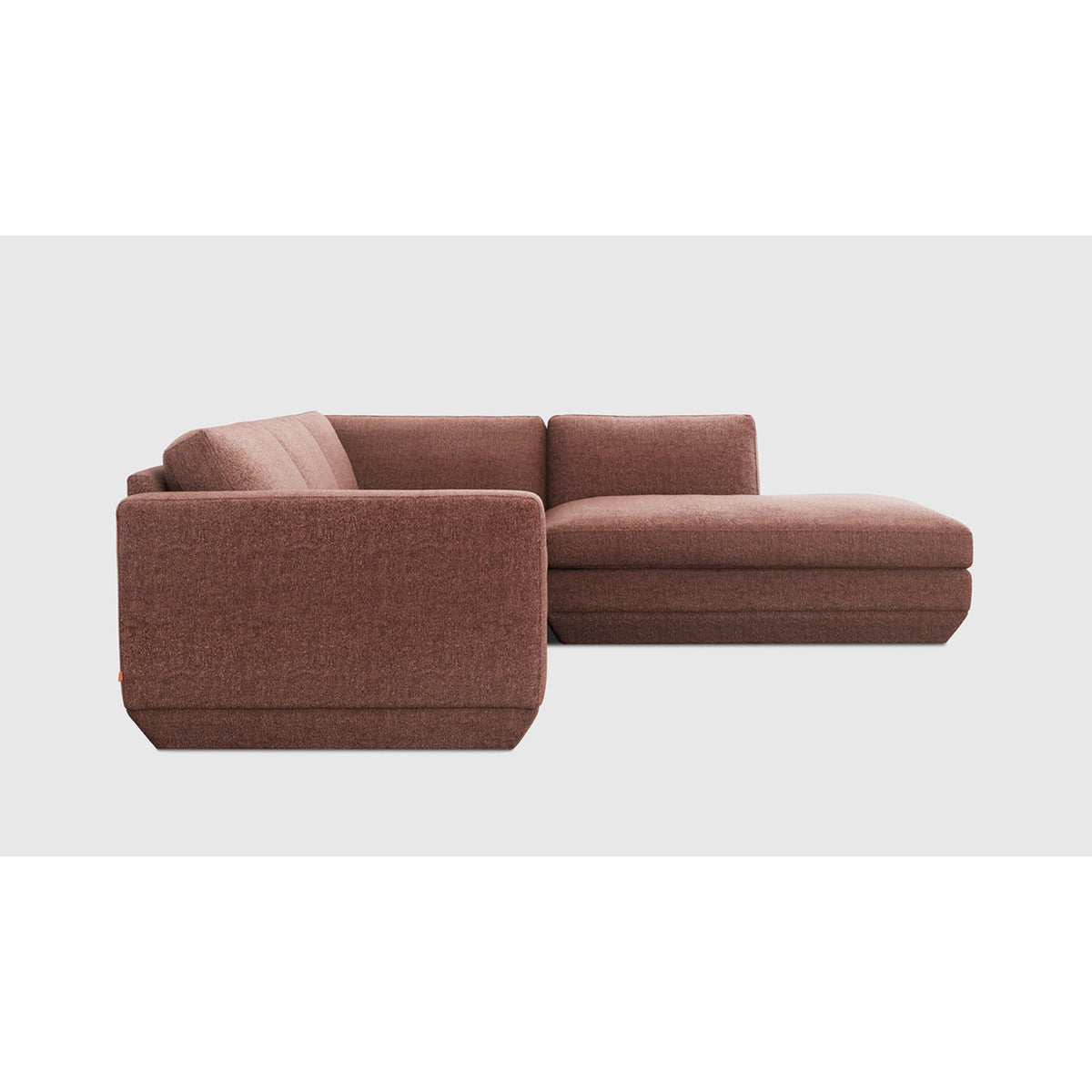 Podium Modular 4PC Lounge Sectional A by Gus* with rust-colored upholstery, chaise-end side profile.