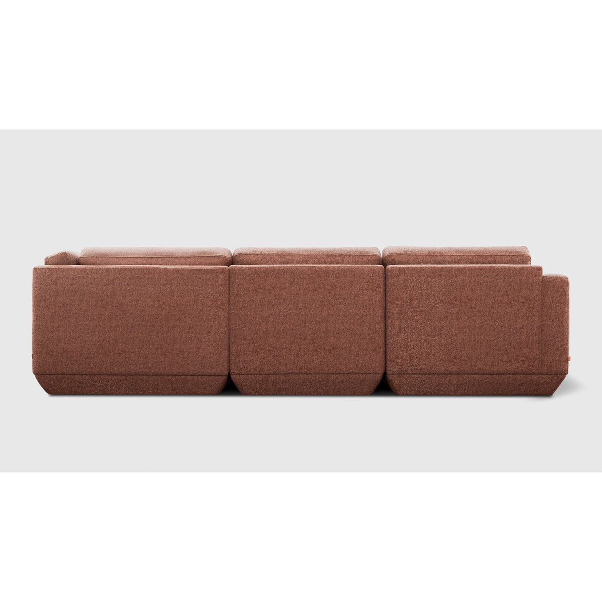 Podium Modular 4PC Lounge Sectional A by Gus* with rust-colored upholstery, straight rear view.