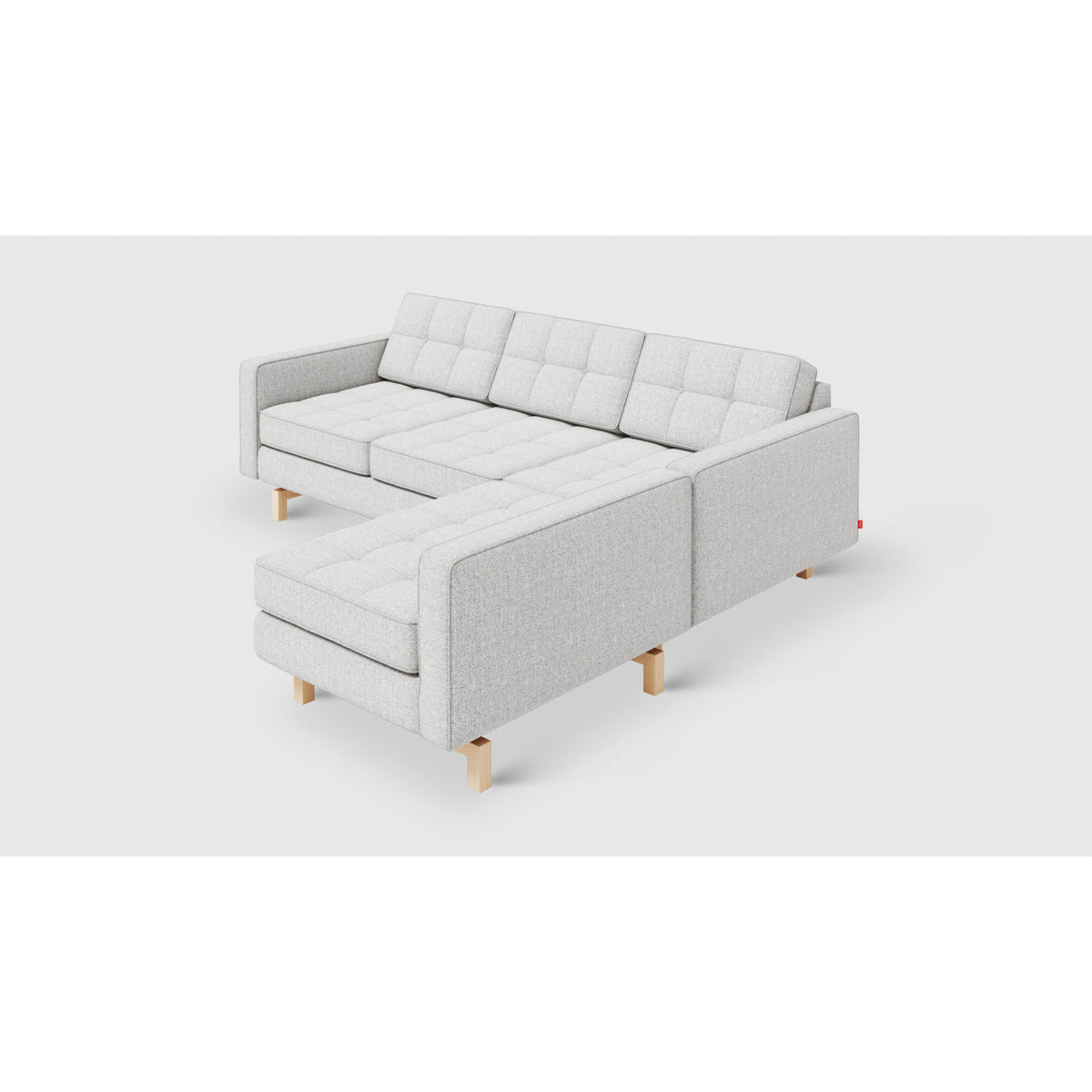 Jane 2 Loft Bi-Sectional by Gus* — angled chaise-side view showing button-tufted cushions and light wood legs