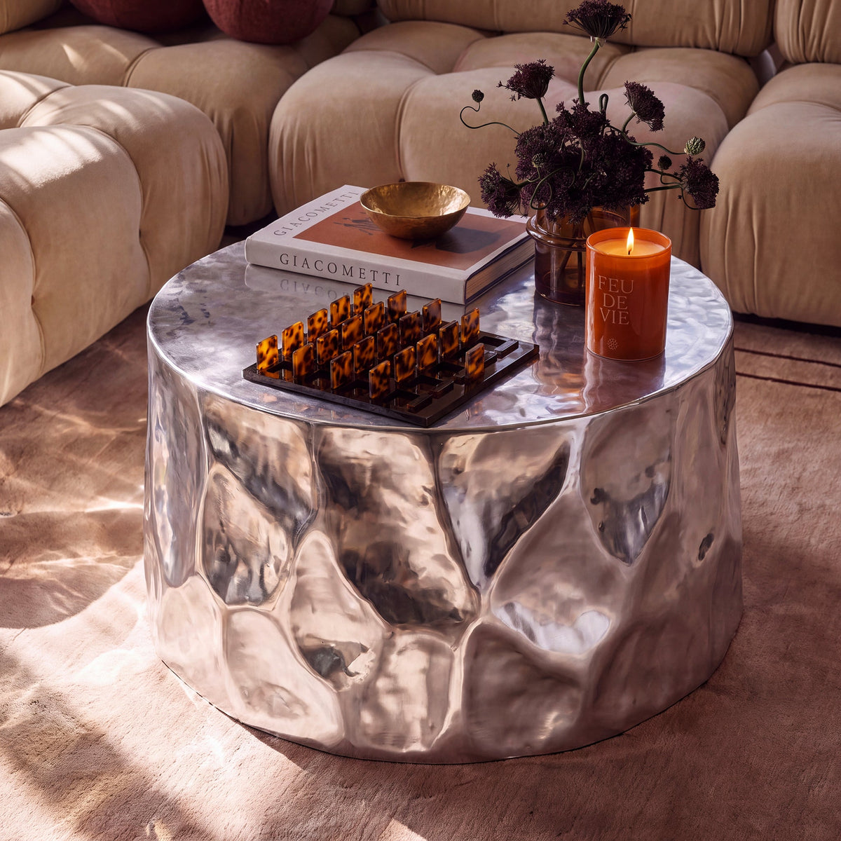 Forma 34" Chrome Coffee Table by TOV Furniture — styled with books and decor in a living room setting.