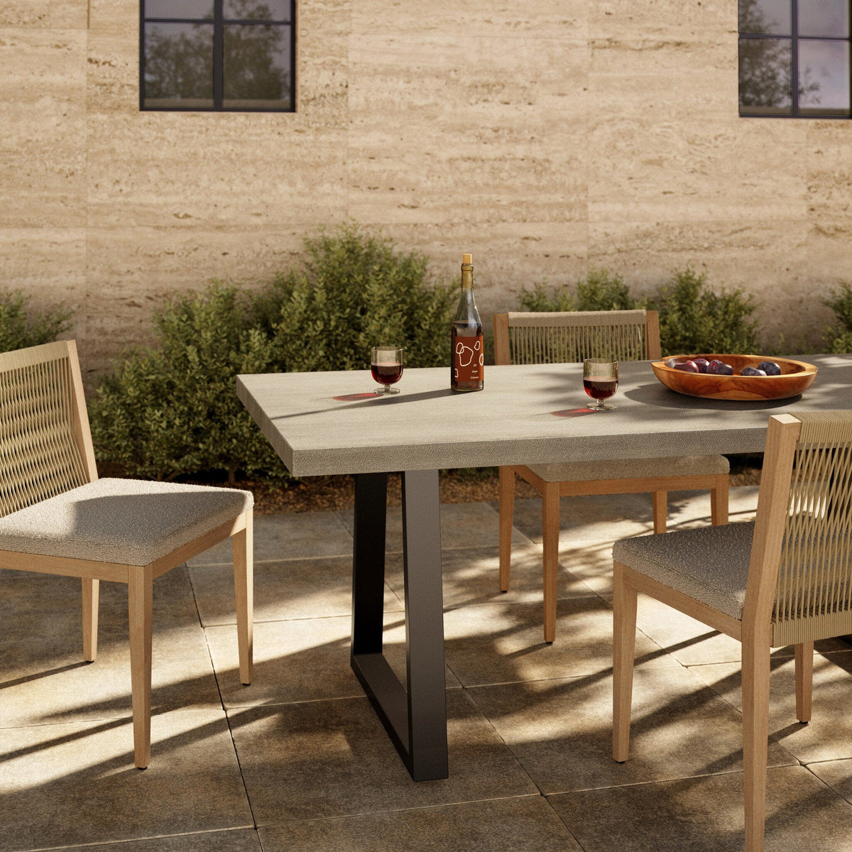 Outdoor dining space featuring the Cyrus Outdoor Dining Table by Four Hands