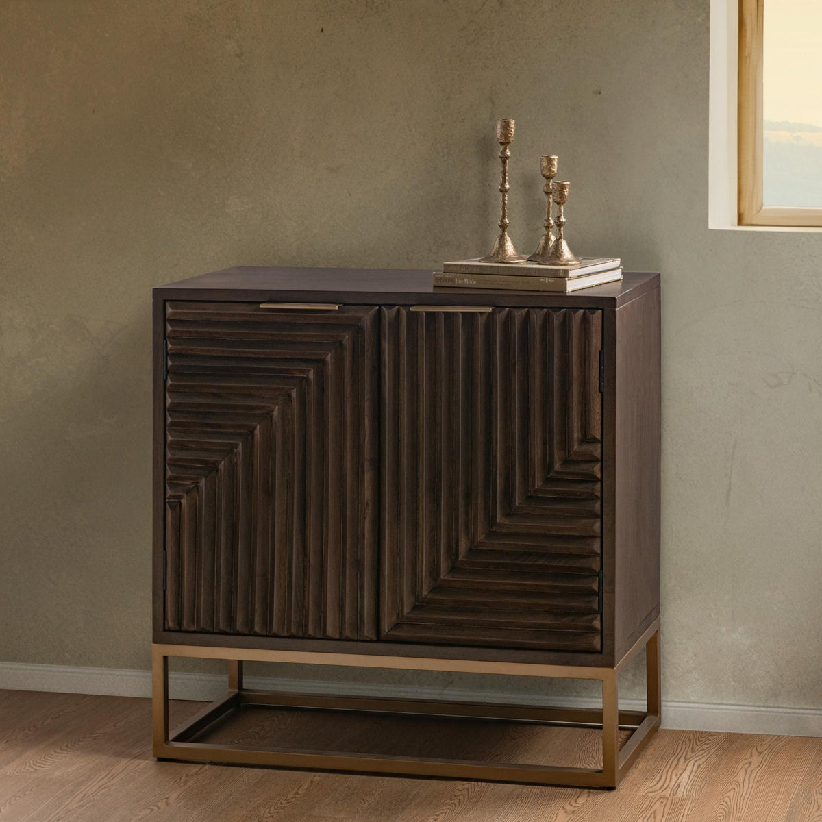 Flint Cabinet by Classic Home — two-door dark brown mango wood cabinet styled in a room with decor on top