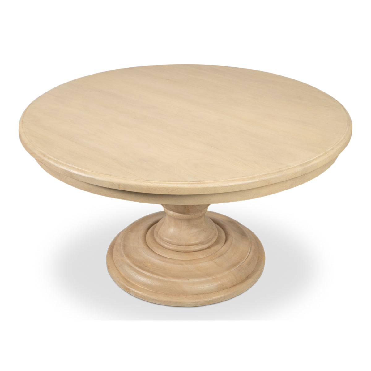 Guillermo Dining Table by Sarreid, angled view of the round natural mango wood top and sculpted pedestal base.
