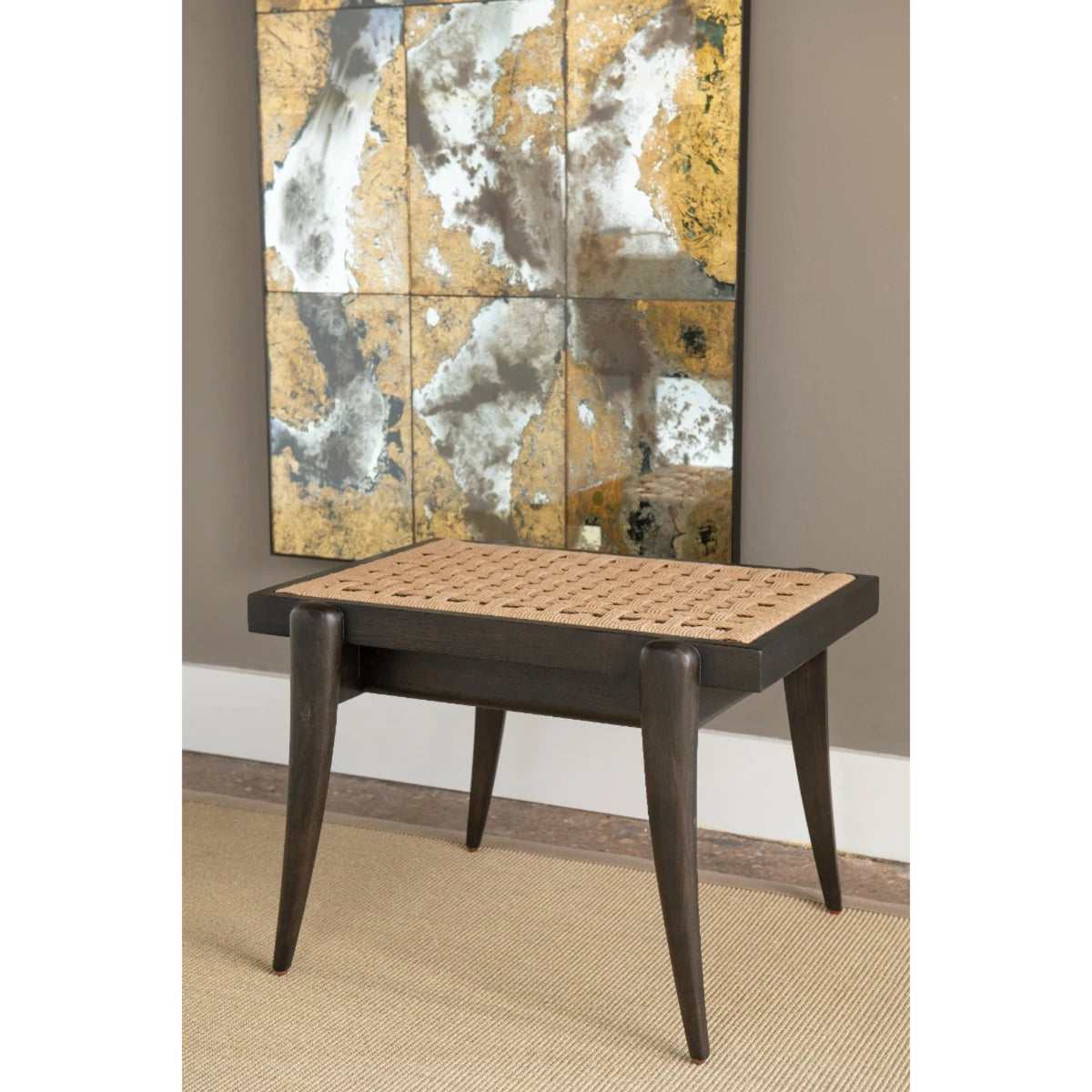 Dylan Stool by Villa & House — dark oak and woven seagrass stool in a styled room setting beneath wall art.