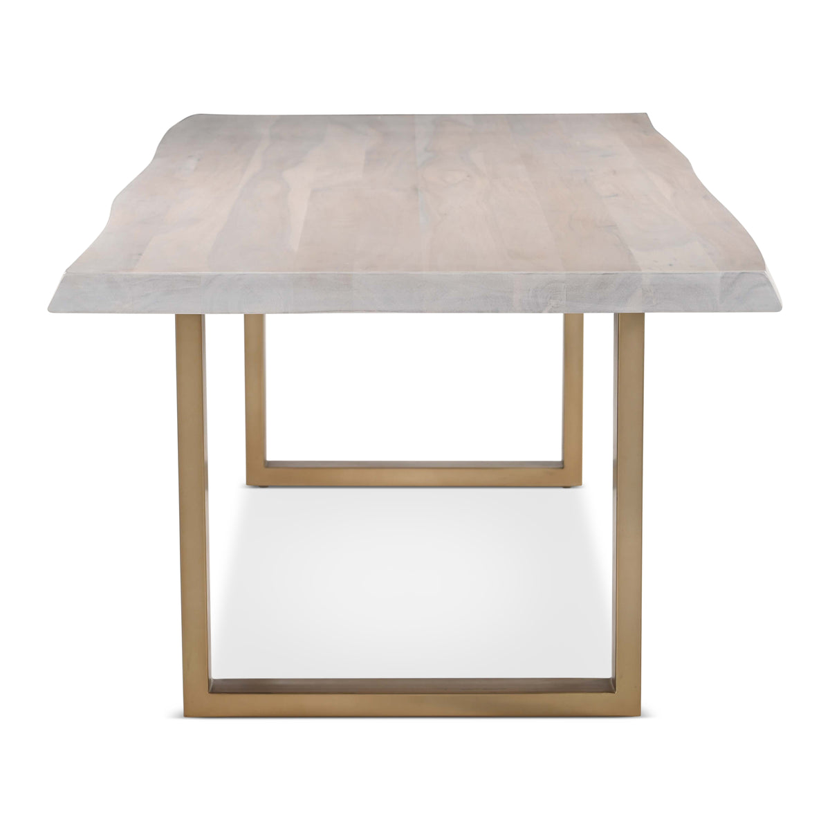 Brooks Dining Table - U Base by Urbia — end view of the pale live-edge acacia top and rectangular gold-toned frame