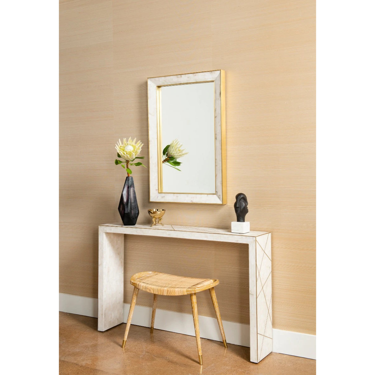 Jerome Stool by Villa & House beneath a white console, showing the hand-woven cane seat in a styled entryway.