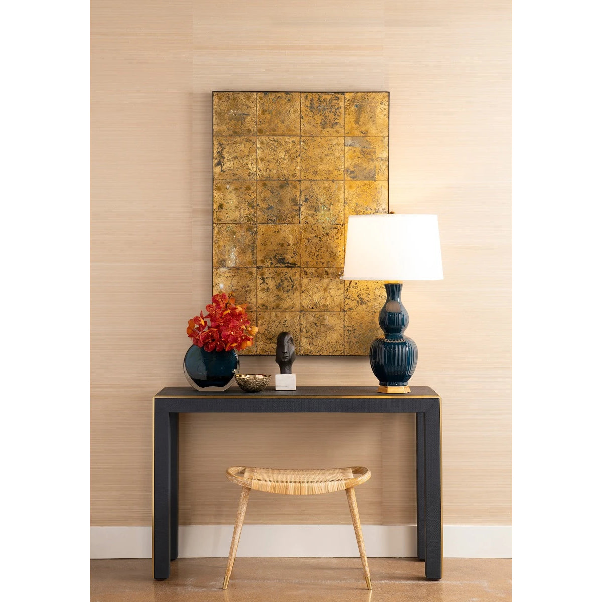 Jerome Stool by Villa & House beneath a black console, showing the curved cane seat in a styled entryway.
