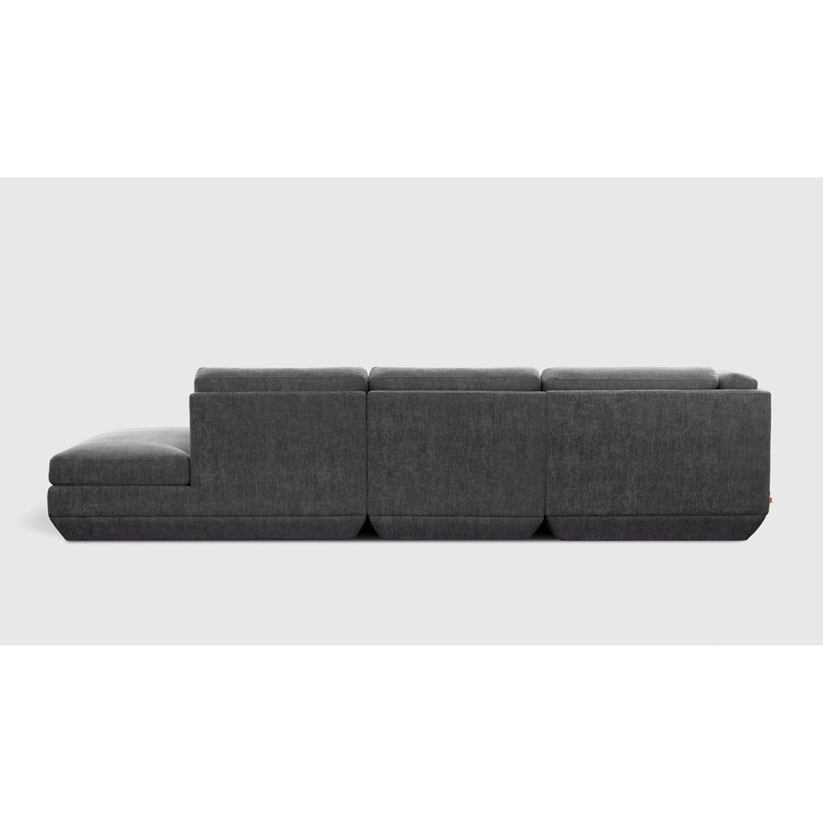 Podium Modular 4PC Lounge Sectional B - LF by Gus* — charcoal-gray upholstery, rear studio view