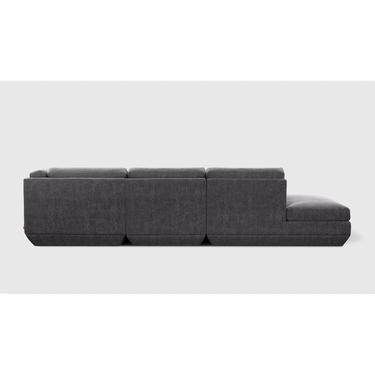 Podium Modular 4PC Lounge Sectional B - RF by Gus* — charcoal-gray upholstery, rear studio view