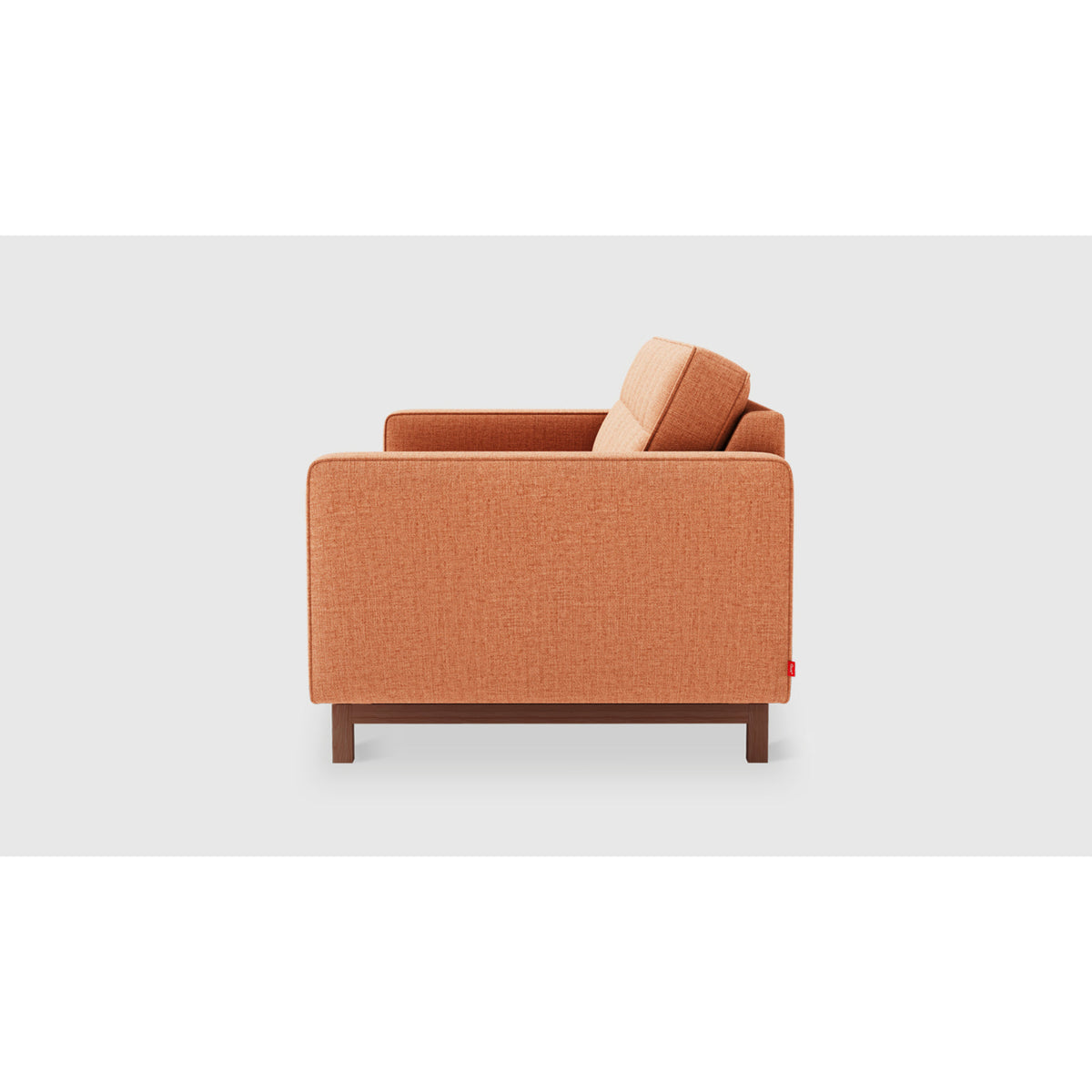 Jane 2 Loft Sofa by Gus* in warm orange upholstery, side profile showing slim track arms and inset wood base