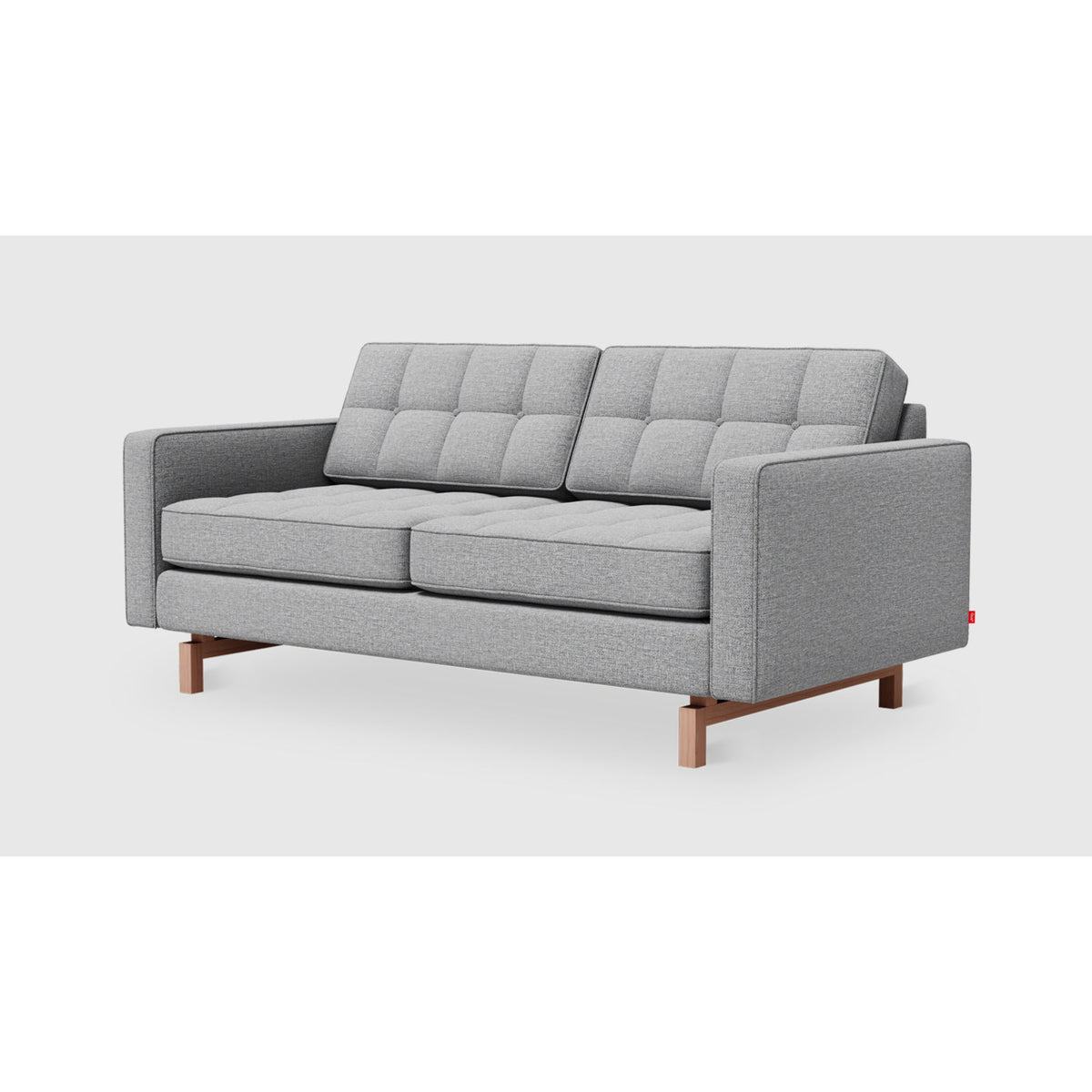 Jane 2 Loft Sofa by Gus* in Parliament Stone upholstery, three-quarter view with button-tufted cushions and inset ash base
