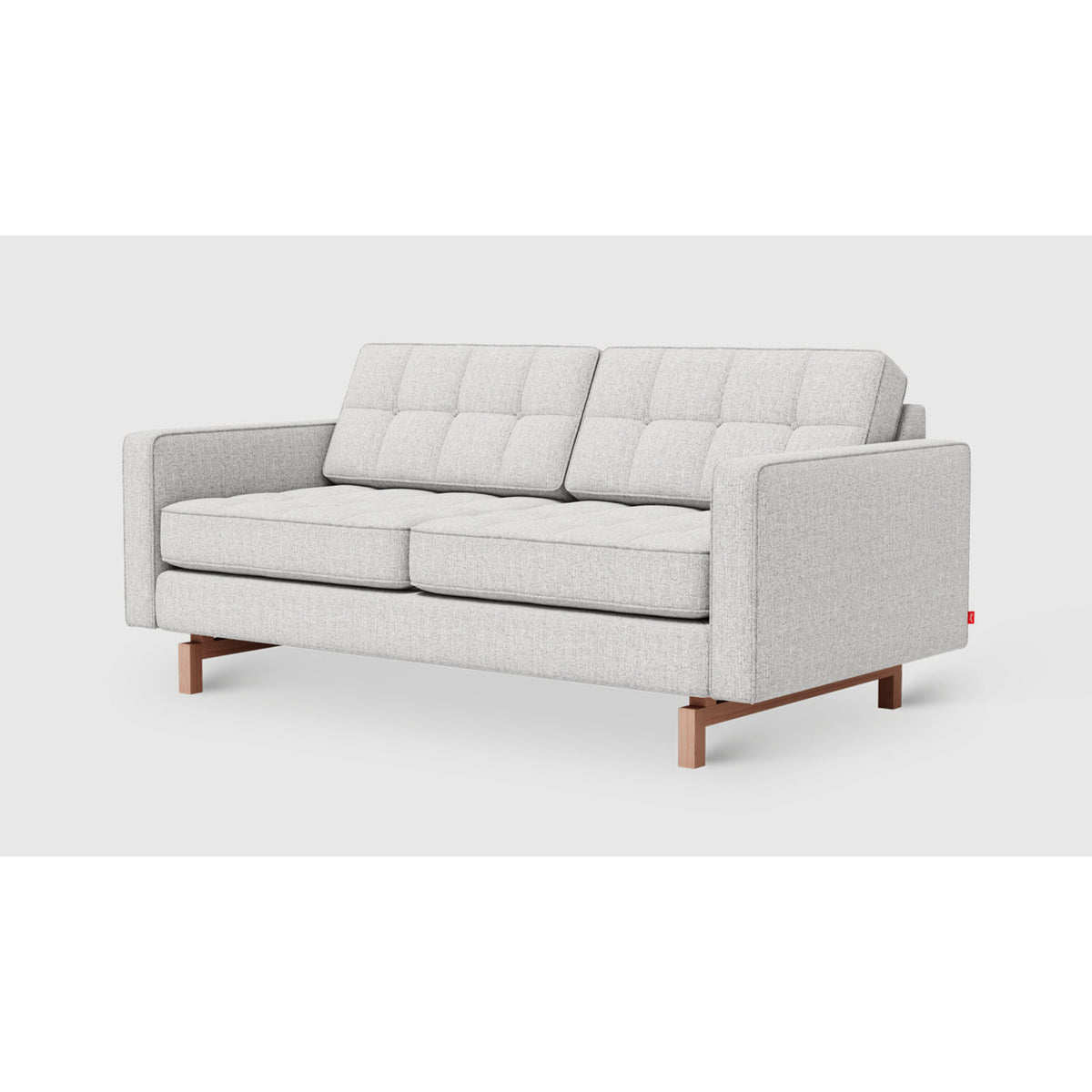 Jane 2 Loft Sofa by Gus* in Robarts Saule upholstery, three-quarter view with button-tufted cushions and inset ash base