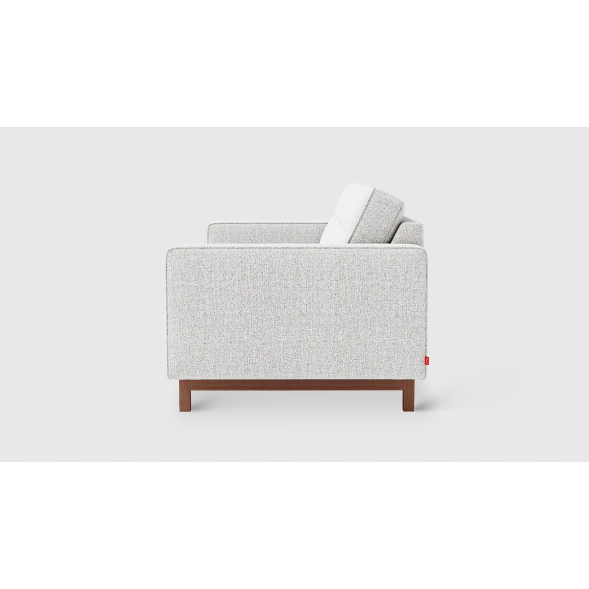 Jane 2 Loft Sofa by Gus* in light gray upholstery, side profile showing slim track arms and inset wood base