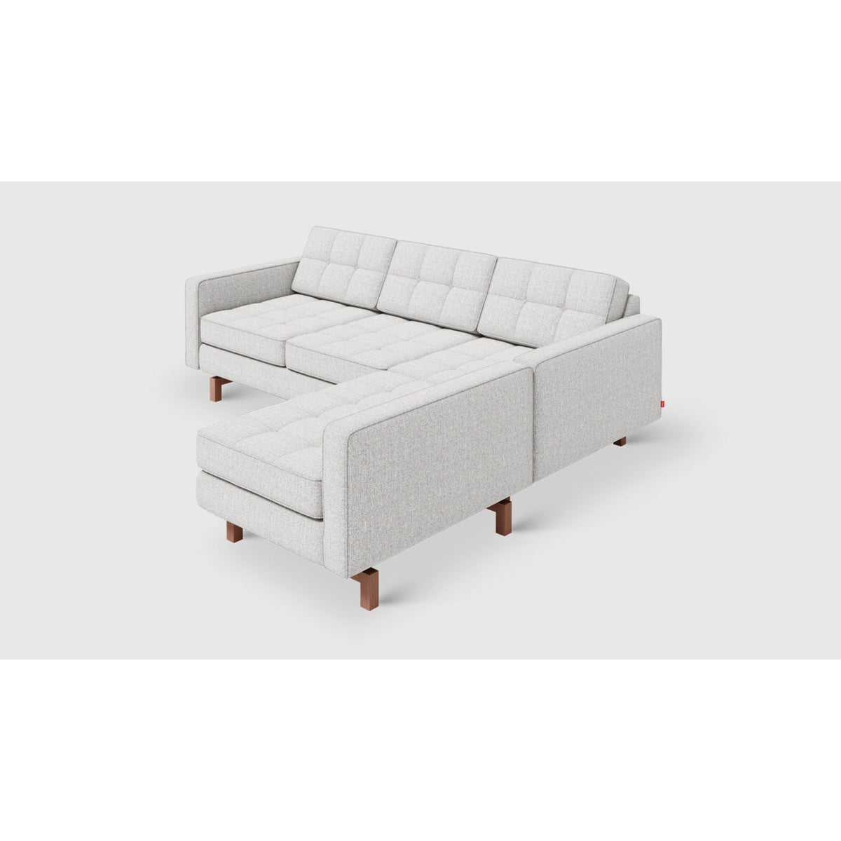 Jane 2 Loft Bi-Sectional by Gus* — angled chaise-side view showing button-tufted cushions and dark wood legs