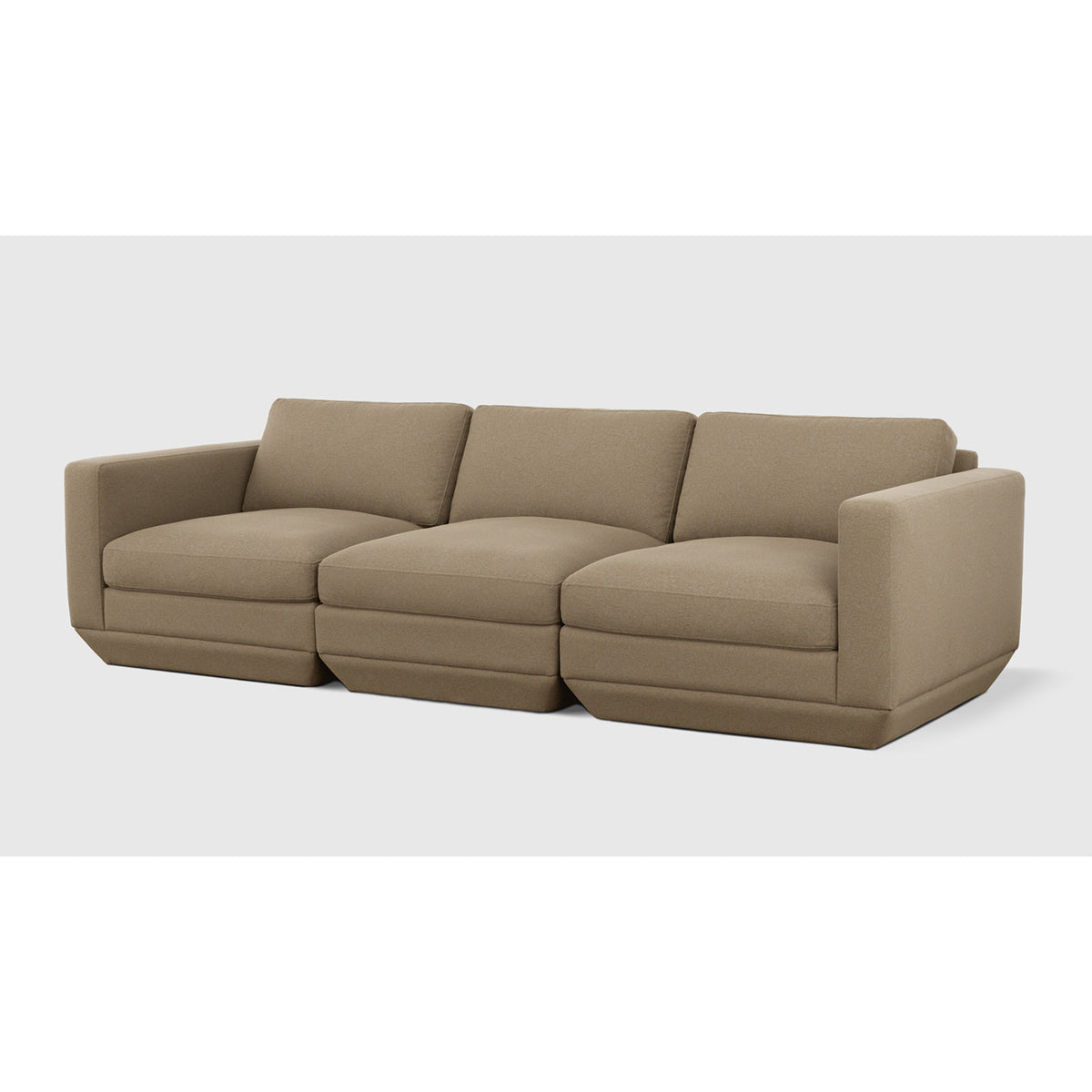 Podium Modular 3PC Sofa by Gus* — warm taupe upholstery, angled view of three connected seating modules