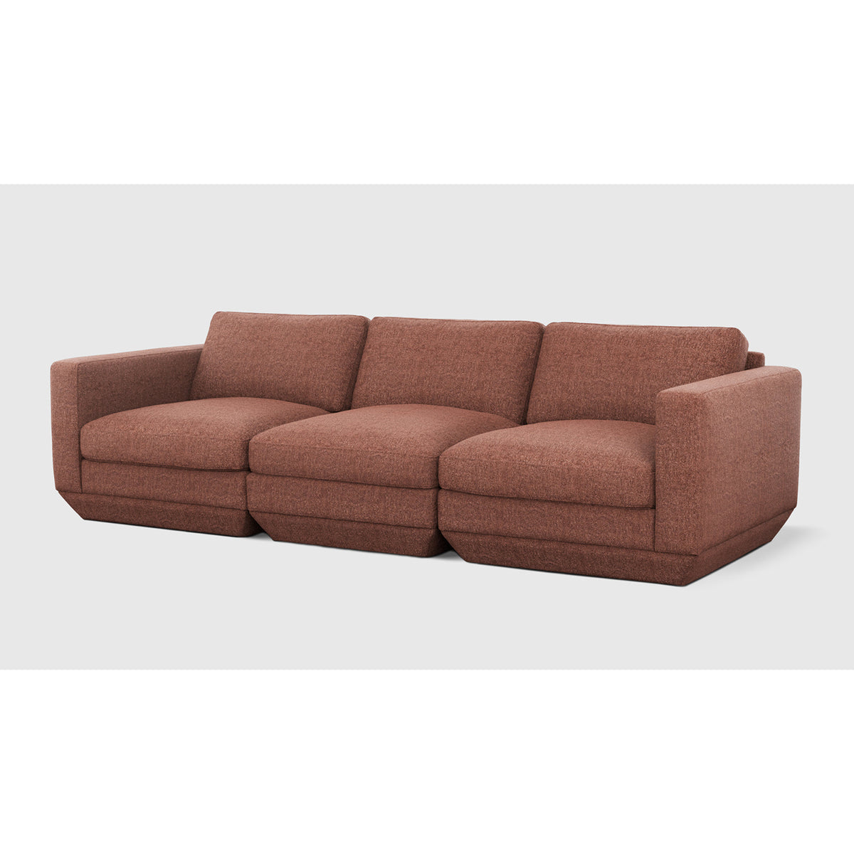 Podium Modular 3PC Sofa by Gus* — rust-toned upholstery, angled view of three connected seating modules