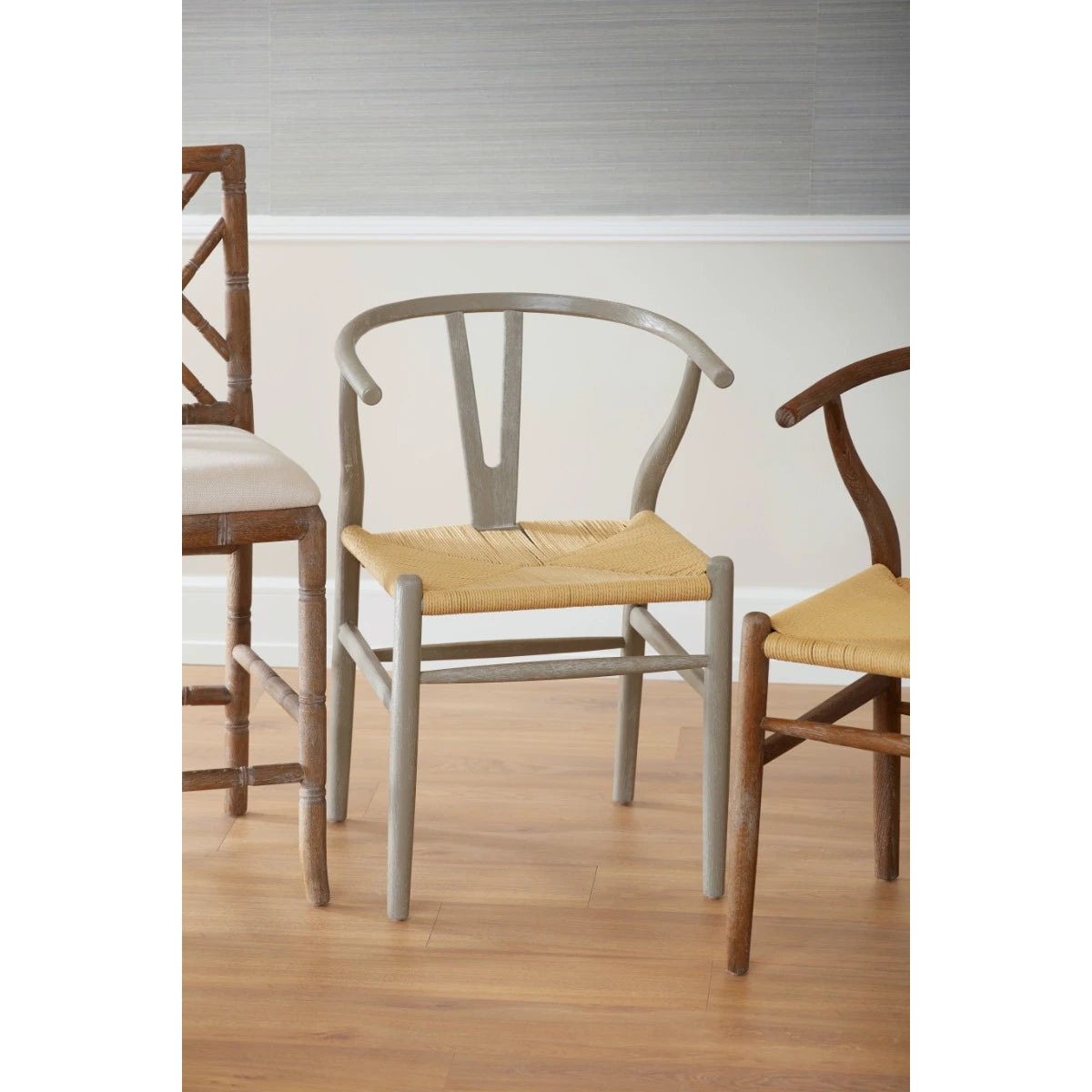 Oslo Armchair by Villa & House — curved oak frame and woven rope seat centered in a dining-room chair grouping.