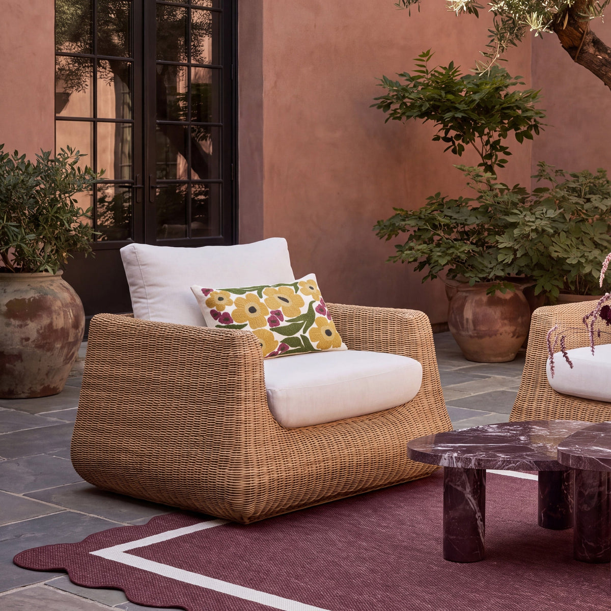 Dana Outdoor Accent Chair by TOV Furniture — cream cushions and resin wicker in a patio setting, front view
