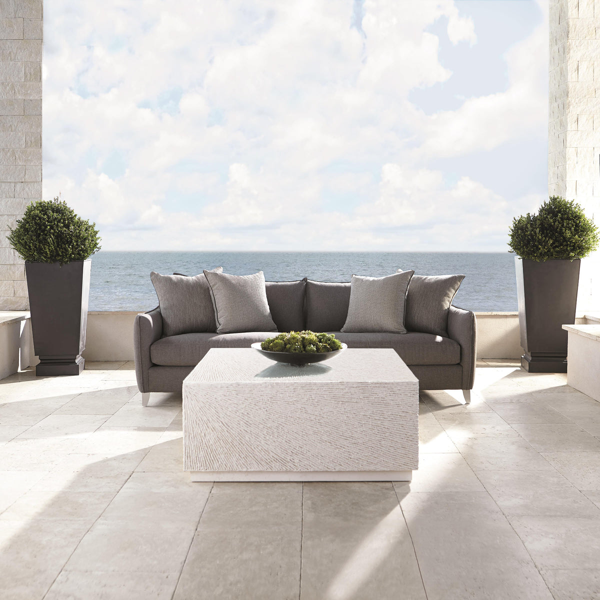 Tenerife Square Coco Twig Outdoor Cocktail Table by Bernhardt on an oceanfront patio