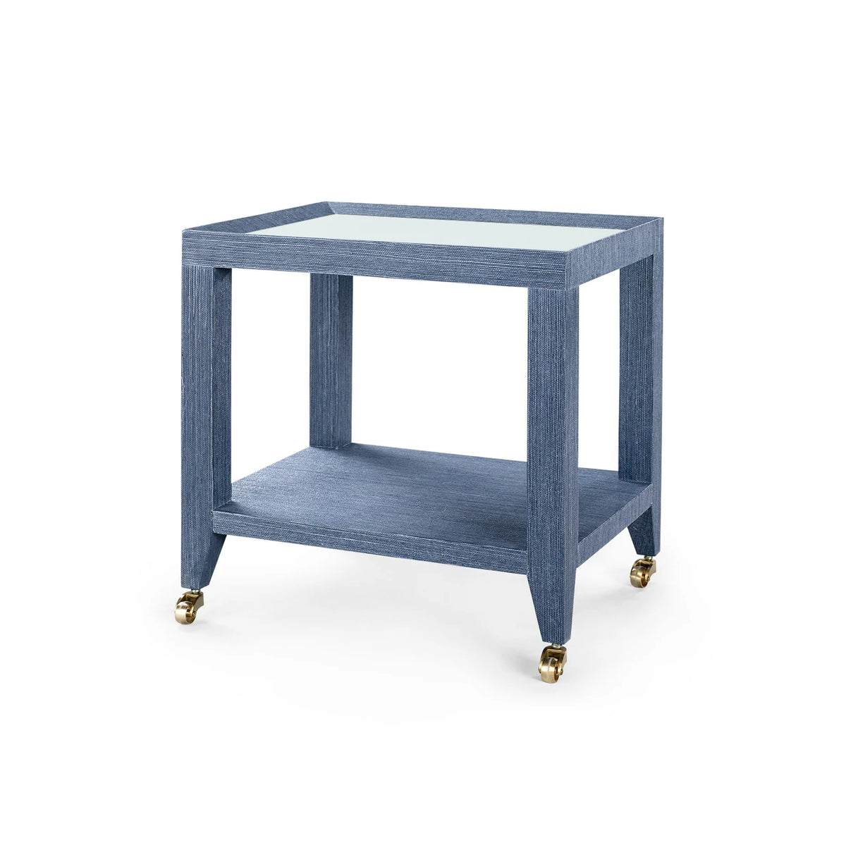 Isadora Tea Table with Glass Top by Villa & House in Navy Blue — angled view with lower shelf and antique-brass casters.